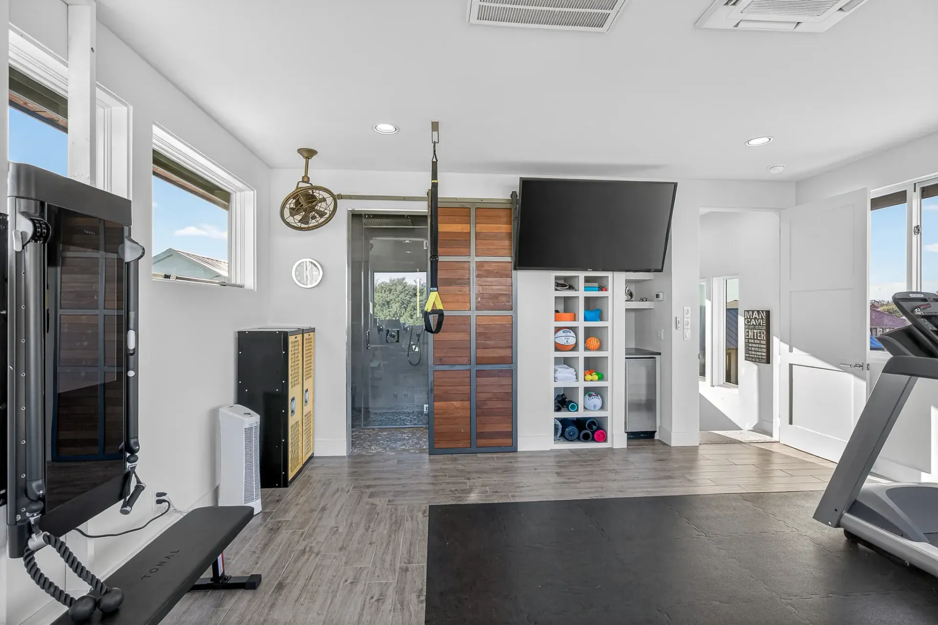 Private home gym with Tonal and walk-in shower